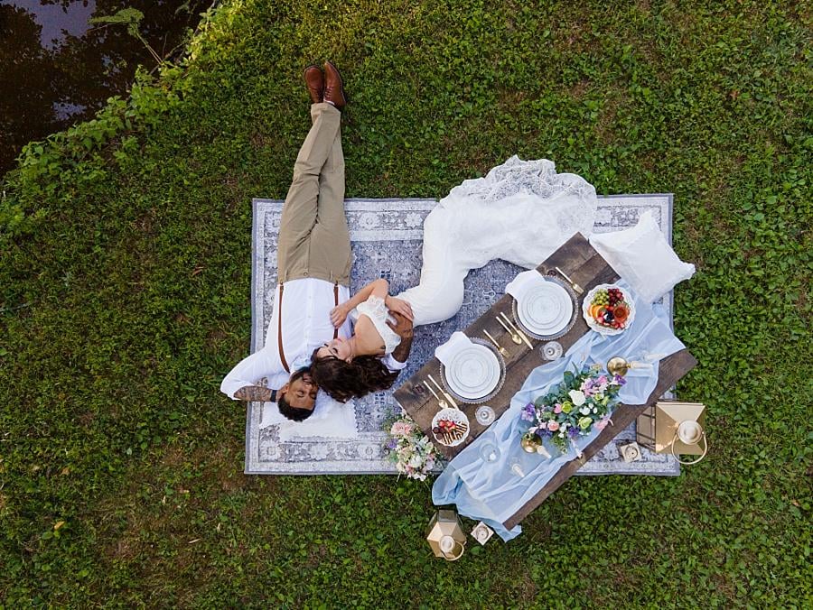 A drone photo of a couple on a blanket